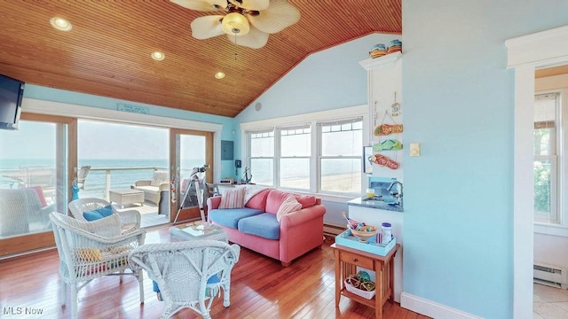 1431 Cedar Point Rd, Sandusky, OH 44870 - living area featuring healthy amount of natural light, lofted ceiling, a baseboard radiator, wood finished floors, and ceiling fan