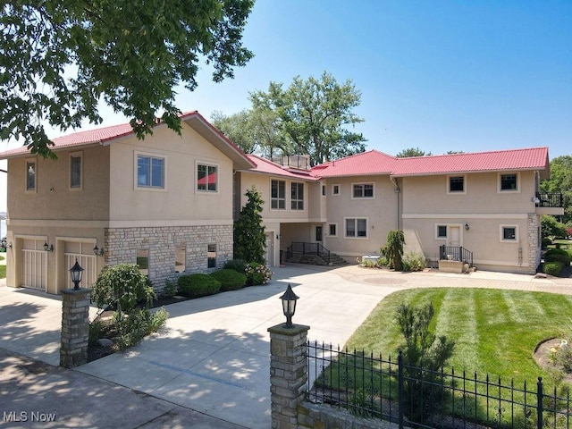 1431 Cedar Point Rd, Sandusky, OH 44870 - view of front of home with stucco siding, stone siding, a garage, and concrete driveway