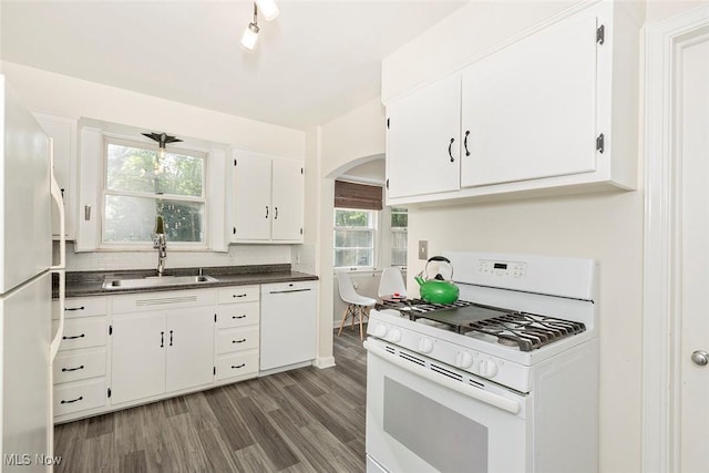 2215 S Belvoir Blvd, University Heights, OH 44118 - kitchen featuring white appliances, arched walkways, dark countertops, and white cabinetry