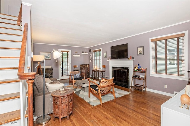 2215 S Belvoir Blvd, University Heights, OH 44118 - living area featuring stairway, wood finished floors, a fireplace with flush hearth, and ornamental molding
