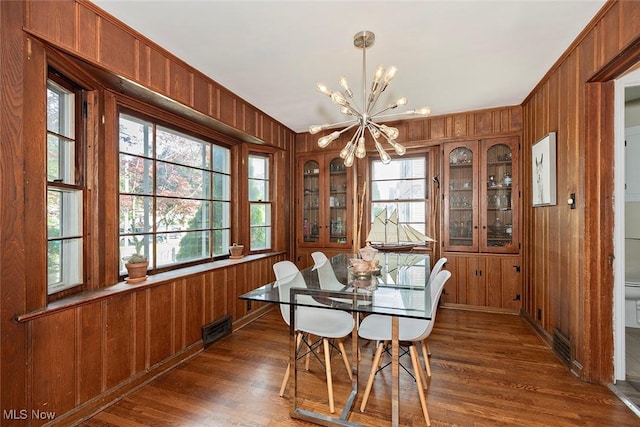 2215 S Belvoir Blvd, University Heights, OH 44118 - dining room with wooden walls, a chandelier, healthy amount of natural light, and dark wood-style floors