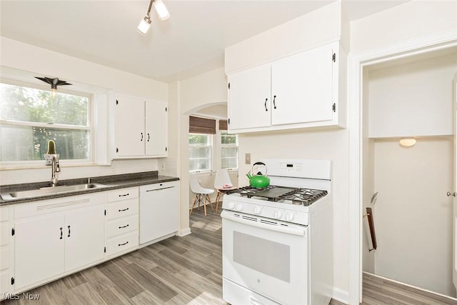 2215 S Belvoir Blvd, University Heights, OH 44118 - kitchen with white appliances, arched walkways, white cabinetry, light wood-style flooring, and dark countertops