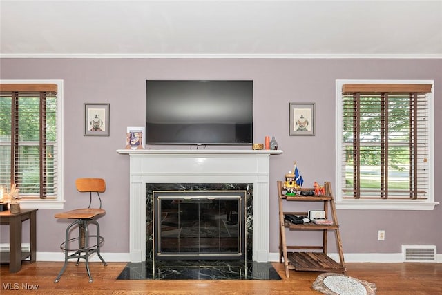 2215 S Belvoir Blvd, University Heights, OH 44118 - living room with wood finished floors, plenty of natural light, ornamental molding, and a fireplace