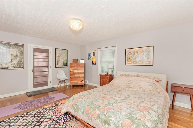 2215 S Belvoir Blvd, University Heights, OH 44118 - bedroom with wood finished floors and a textured ceiling