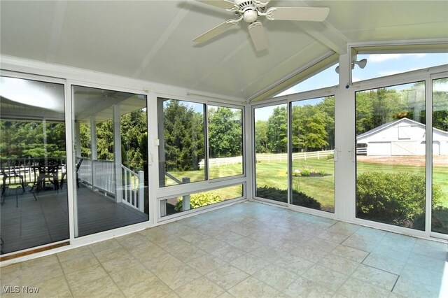 11919 Claridon Troy Rd, Chardon, OH 44024 - unfurnished sunroom featuring ceiling fan, lofted ceiling, and view of wooded area