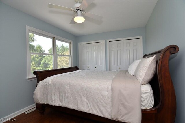 11919 Claridon Troy Rd, Chardon, OH 44024 - bedroom with two closets, dark wood-type flooring, and a ceiling fan