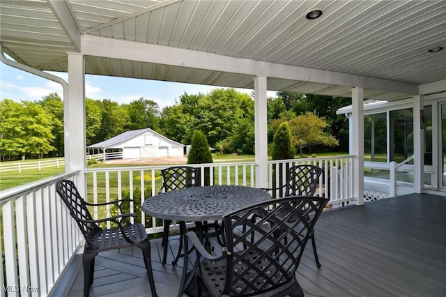 11919 Claridon Troy Rd, Chardon, OH 44024 - wooden terrace featuring outdoor dining space, view of scattered trees, and a yard