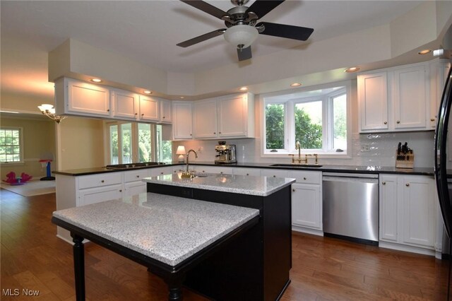 11919 Claridon Troy Rd, Chardon, OH 44024 - kitchen featuring stainless steel dishwasher, dark wood-type flooring, black cooktop, white cabinetry, and backsplash