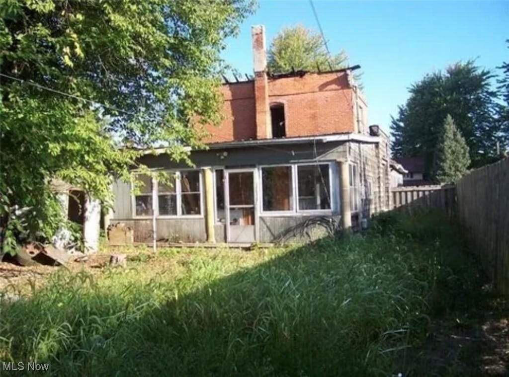 411 E Lima St, Forest, OH 45843 - back of property with a sunroom and a fenced backyard
