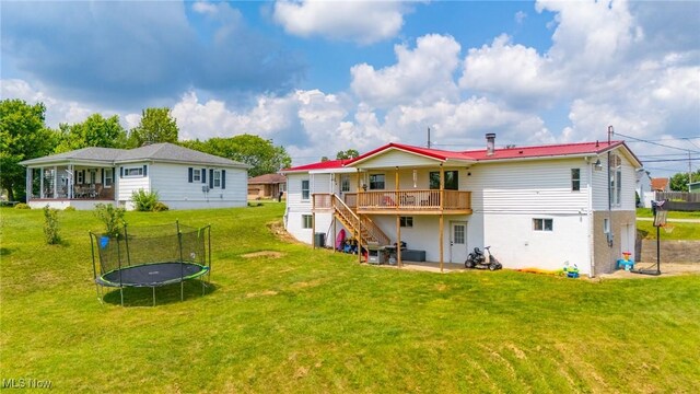 208 Jefferson Blvd, Mingo Junction, OH 43938 - rear view of house with a trampoline, stairs, a lawn, a deck, and a patio area