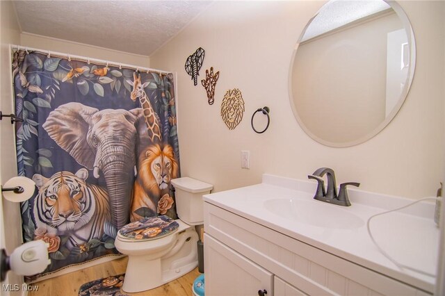 208 Jefferson Blvd, Mingo Junction, OH 43938 - full bathroom with wood finished floors, vanity, a textured ceiling, and curtained shower
