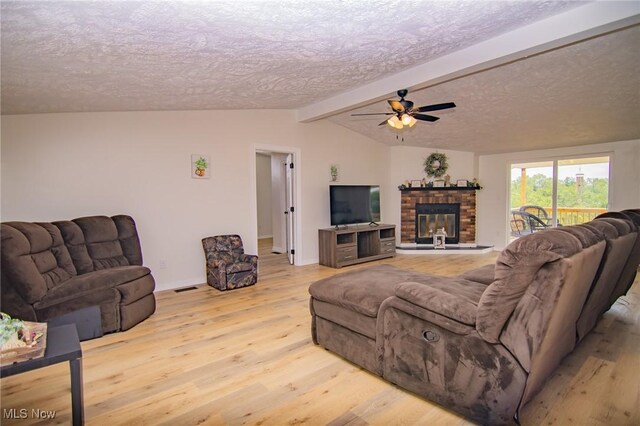 208 Jefferson Blvd, Mingo Junction, OH 43938 - living area featuring a textured ceiling, wood finished floors, a ceiling fan, and a glass covered fireplace