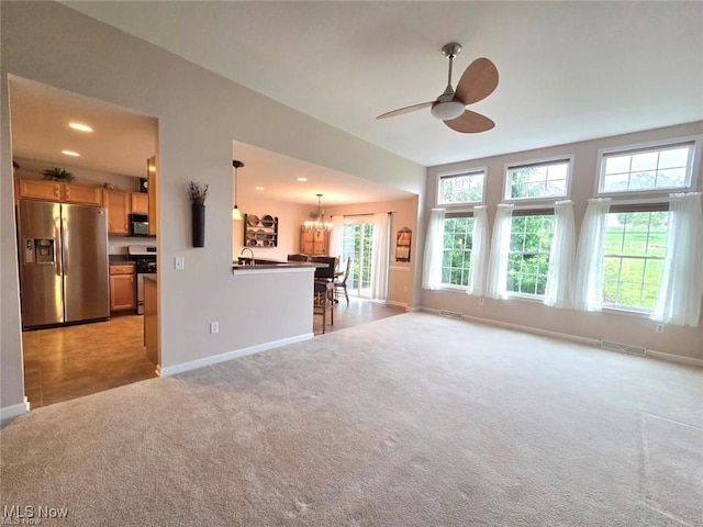 125 Fitch Blvd Unit 263, Austintown, OH 44515 - unfurnished living room featuring light carpet, a chandelier, ceiling fan, and recessed lighting