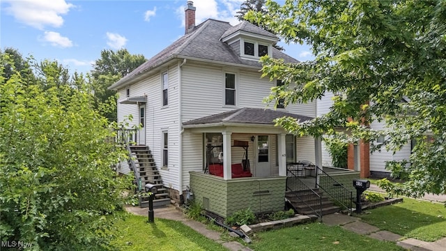 415 N Columbus St, Crestline, OH 44827 - traditional style home featuring stairway, a chimney, a front lawn, and roof with shingles