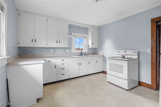 415 N Columbus St, Crestline, OH 44827 - kitchen featuring white electric range, light countertops, and white cabinets