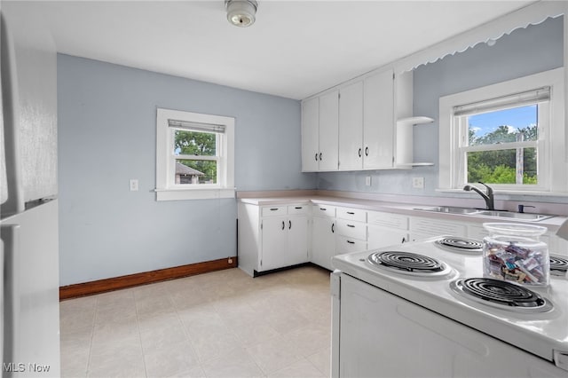415 N Columbus St, Crestline, OH 44827 - kitchen with electric stove, plenty of natural light, light countertops, and freestanding refrigerator