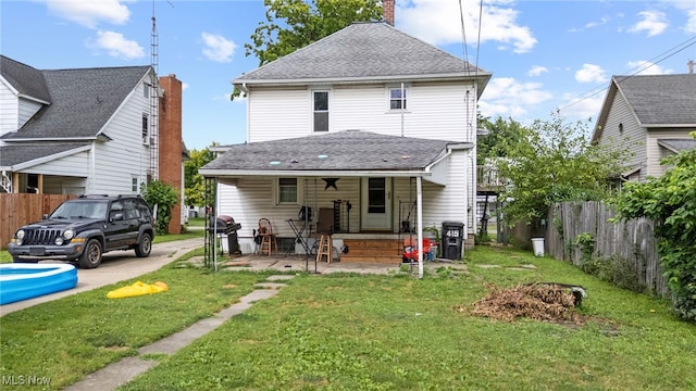 415 N Columbus St, Crestline, OH 44827 - rear view of property featuring a chimney and a shingled roof
