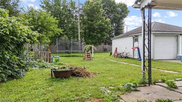 415 N Columbus St, Crestline, OH 44827 - view of yard featuring a trampoline and a detached garage