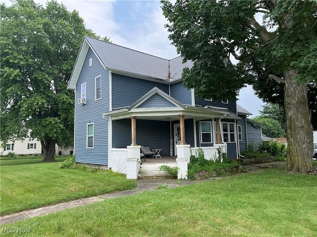 45055 N Ridge Rd, Amherst, OH 44001 - view of front of house featuring a porch, a front lawn, and a metal roof