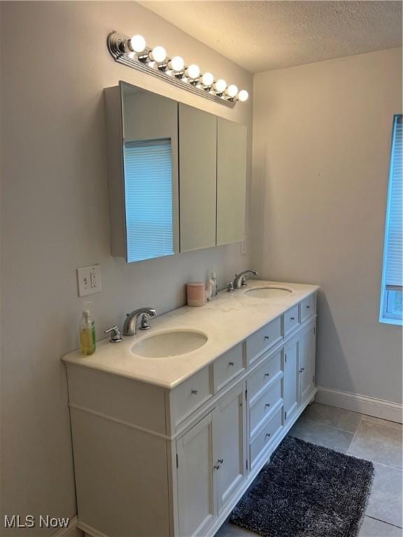 45055 N Ridge Rd, Amherst, OH 44001 - full bathroom with double vanity, tile patterned floors, and a textured ceiling