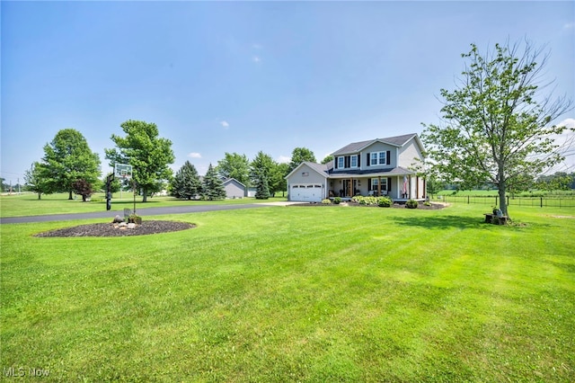 12208 State Route 113, Wakeman, OH 44889 - view of yard featuring asphalt driveway and an attached garage
