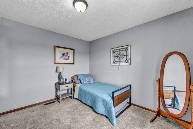 12208 State Route 113, Wakeman, OH 44889 - carpeted bedroom featuring baseboards and a textured ceiling