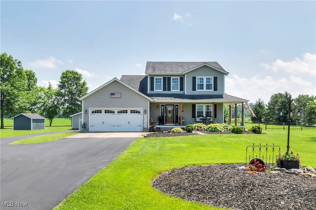 12208 State Route 113, Wakeman, OH 44889 - view of front of house featuring asphalt driveway, a garage, covered porch, and a storage unit