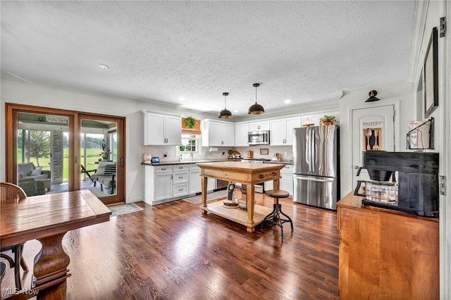 12208 State Route 113, Wakeman, OH 44889 - kitchen with appliances with stainless steel finishes, a textured ceiling, white cabinets, dark wood-style flooring, and crown molding