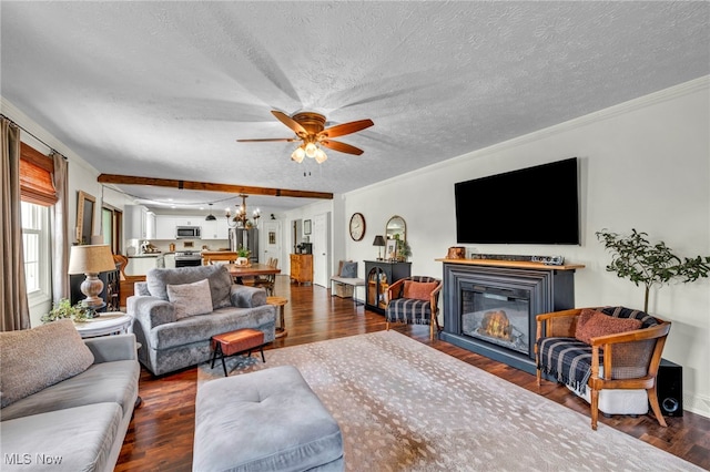12208 State Route 113, Wakeman, OH 44889 - living room featuring a ceiling fan, a glass covered fireplace, a textured ceiling, dark wood finished floors, and crown molding