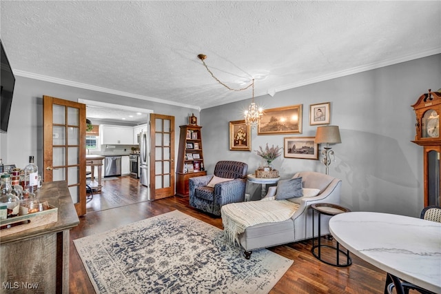 12208 State Route 113, Wakeman, OH 44889 - living area featuring wood finished floors, a textured ceiling, ornamental molding, french doors, and a chandelier
