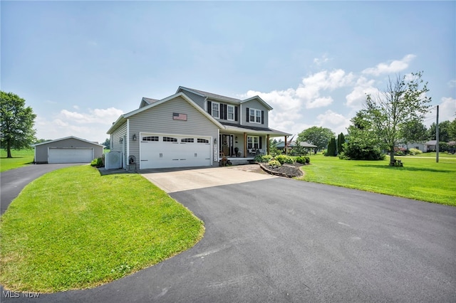 12208 State Route 113, Wakeman, OH 44889 - view of front of home with a front lawn, driveway, a porch, and a garage