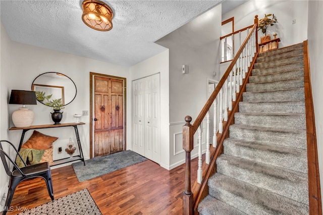 12208 State Route 113, Wakeman, OH 44889 - entryway featuring wood finished floors, stairs, and a textured ceiling