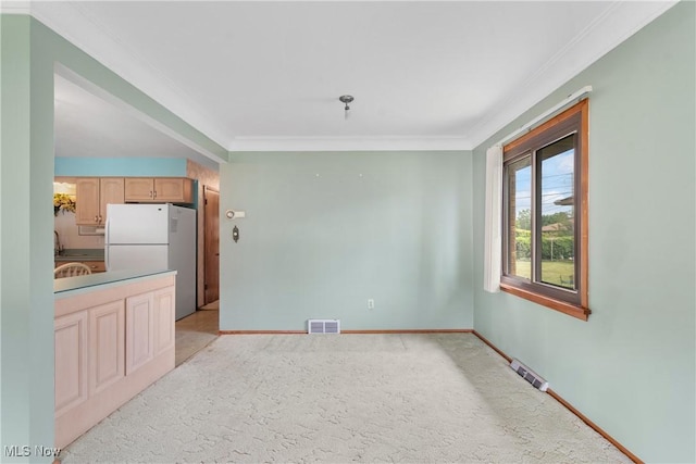 4899 Autumn Ln, Brooklyn, OH 44144 - kitchen featuring crown molding, freestanding refrigerator, light carpet, and light brown cabinetry