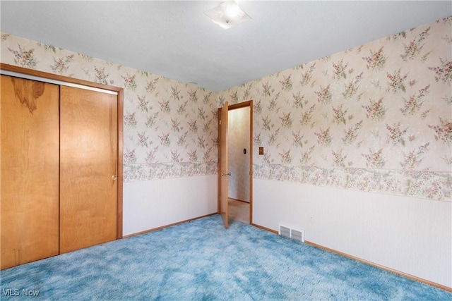 4899 Autumn Ln, Brooklyn, OH 44144 - unfurnished bedroom with a wainscoted wall, carpet flooring, a closet, and wallpapered walls