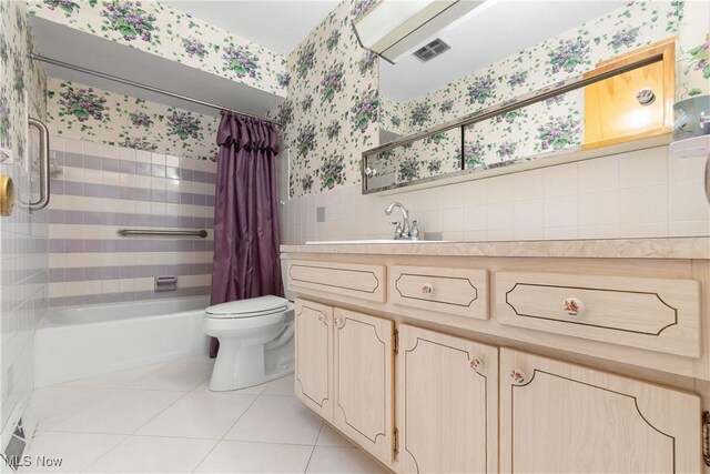 4899 Autumn Ln, Brooklyn, OH 44144 - bathroom featuring tile walls, wallpapered walls, tile patterned flooring, shower / tub combo, and vanity