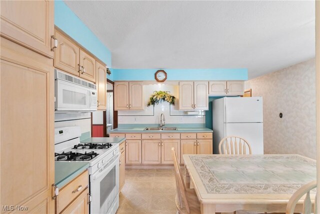 4899 Autumn Ln, Brooklyn, OH 44144 - kitchen featuring white appliances, light brown cabinets, wallpapered walls, and light countertops