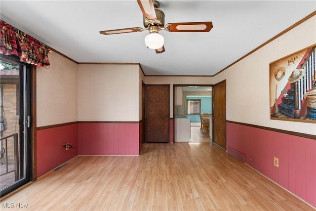 4899 Autumn Ln, Brooklyn, OH 44144 - spare room with wood finished floors, crown molding, wainscoting, and ceiling fan