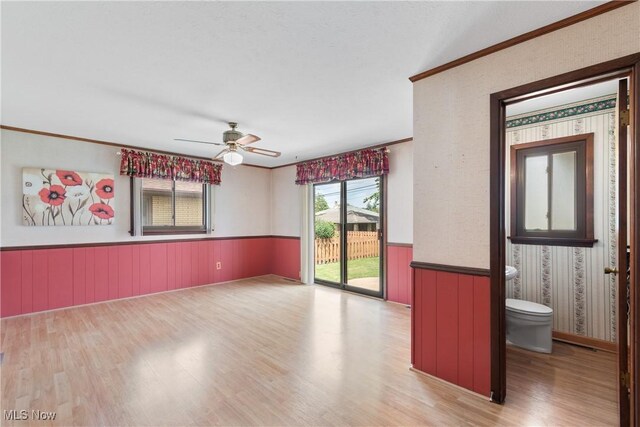 4899 Autumn Ln, Brooklyn, OH 44144 - spare room featuring wood finished floors, a wainscoted wall, ceiling fan, and ornamental molding