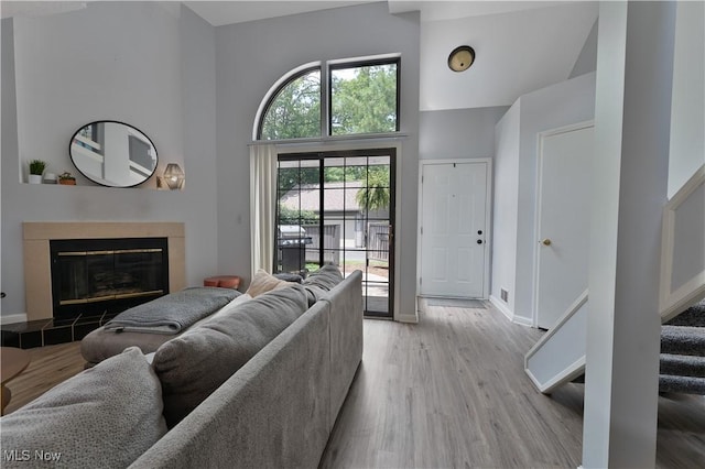 1173 Red Tail Hawk Ct Unit 4, Youngstown, OH 44512 - living room with a towering ceiling, light wood-style flooring, a fireplace, and stairway