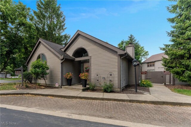 1173 Red Tail Hawk Ct Unit 4, Youngstown, OH 44512 - view of front of home featuring a gate and a chimney
