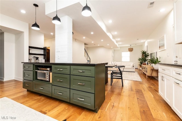 1906 W 47th St, Cleveland, OH 44102 - kitchen with green cabinetry, white cabinets, light wood-style floors, dark countertops, and recessed lighting