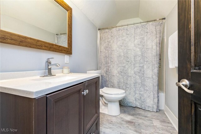 1906 W 47th St, Cleveland, OH 44102 - full bathroom featuring vaulted ceiling, vanity, wood finished floors, and shower / tub combo with curtain