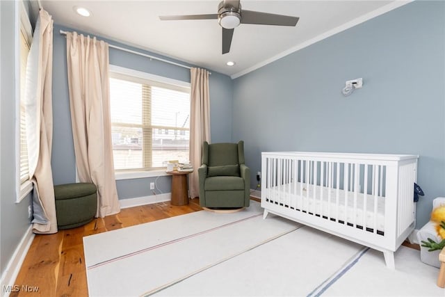 1906 W 47th St, Cleveland, OH 44102 - bedroom featuring wood finished floors, a nursery area, recessed lighting, ornamental molding, and ceiling fan