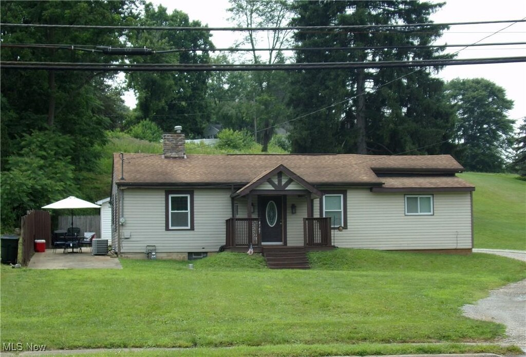 4707 Cleveland Ave S, Canton, OH 44707 - ranch-style house with a chimney, a patio, and a front lawn