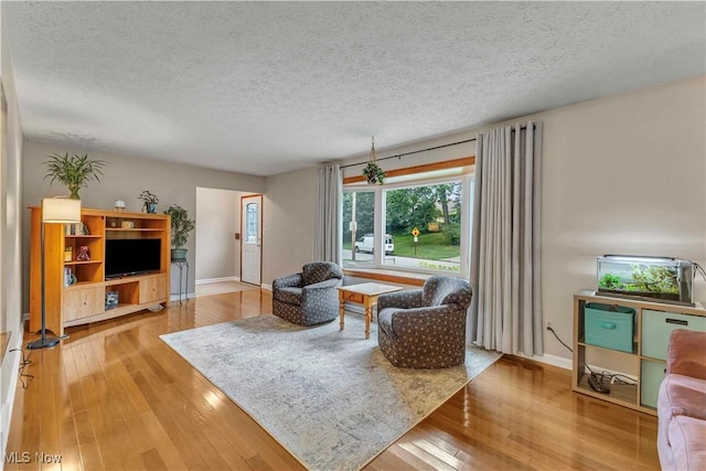 4090 Ridgeview Rd, Cleveland, OH 44144 - living area featuring a textured ceiling and hardwood / wood-style floors