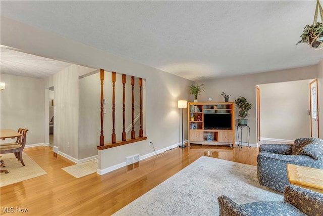 4090 Ridgeview Rd, Cleveland, OH 44144 - living room featuring wood finished floors, a chandelier, and stairway