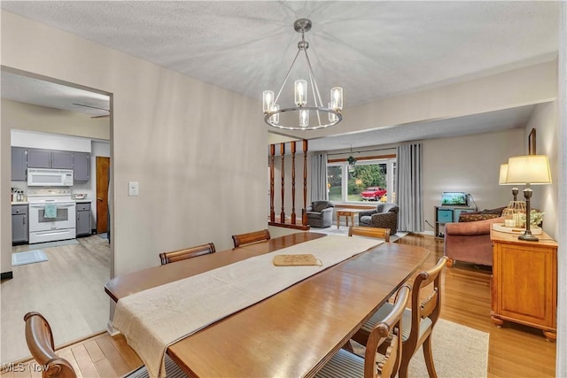4090 Ridgeview Rd, Cleveland, OH 44144 - dining area with light wood-style flooring and a chandelier