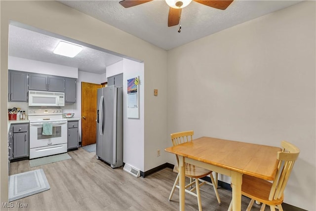 4090 Ridgeview Rd, Cleveland, OH 44144 - kitchen featuring white appliances, light wood-style flooring, gray cabinets, a textured ceiling, and ceiling fan