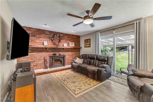 4090 Ridgeview Rd, Cleveland, OH 44144 - living area with a textured ceiling, wood finished floors, ceiling fan, and a fireplace