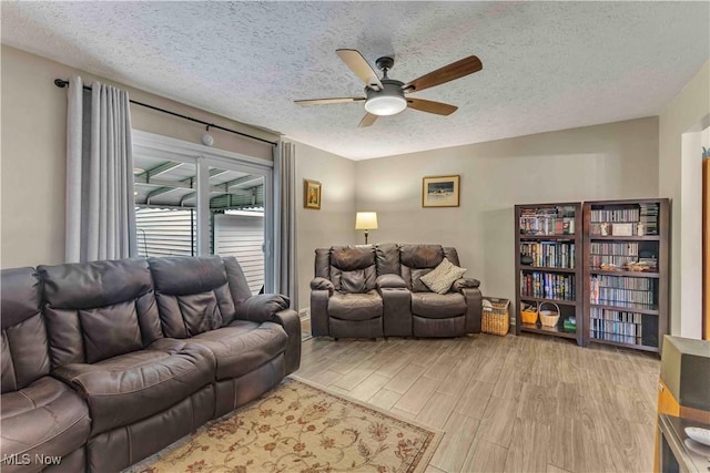 4090 Ridgeview Rd, Cleveland, OH 44144 - living room featuring ceiling fan, wood finished floors, and a textured ceiling